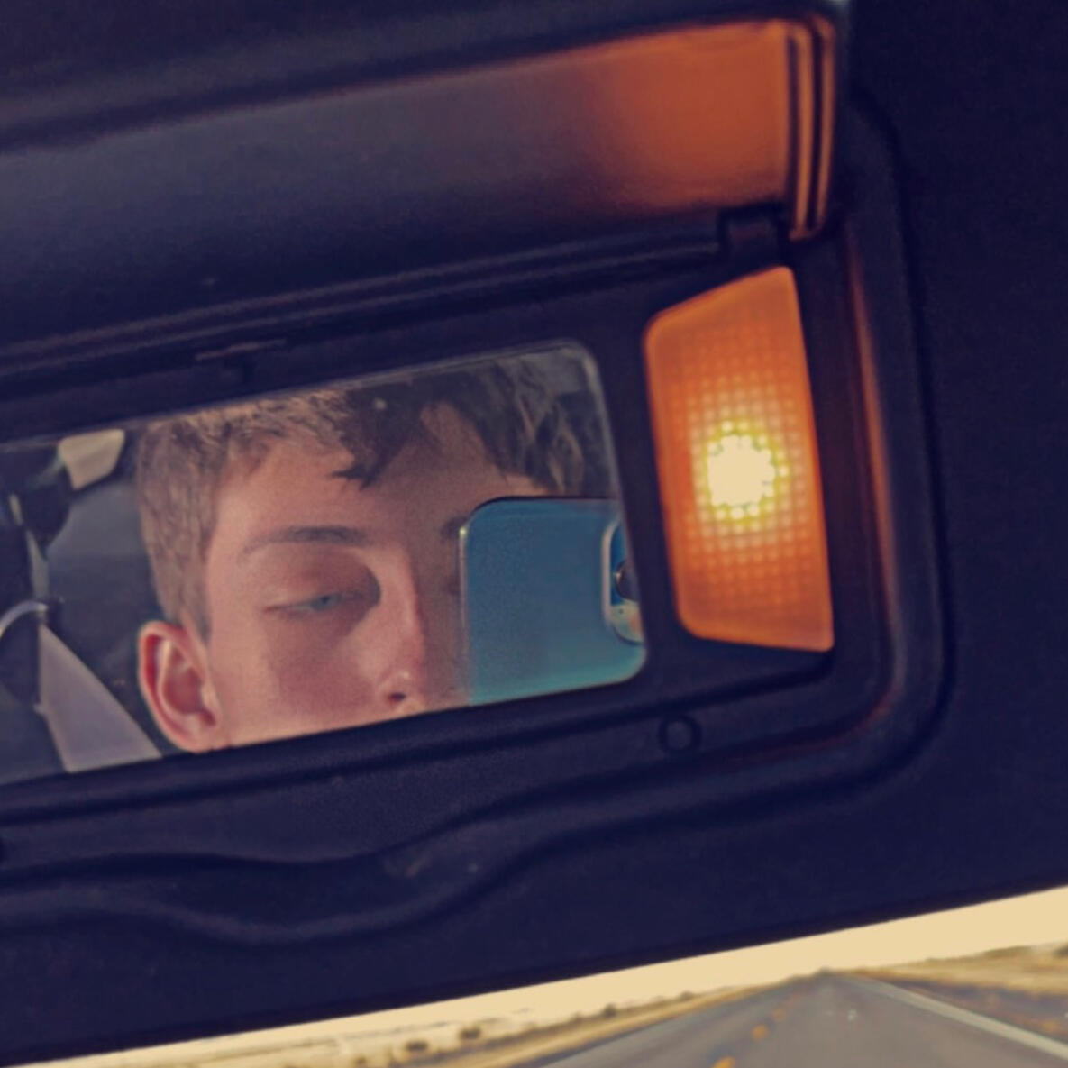 Car mirror selfie of Zackery Lightner.